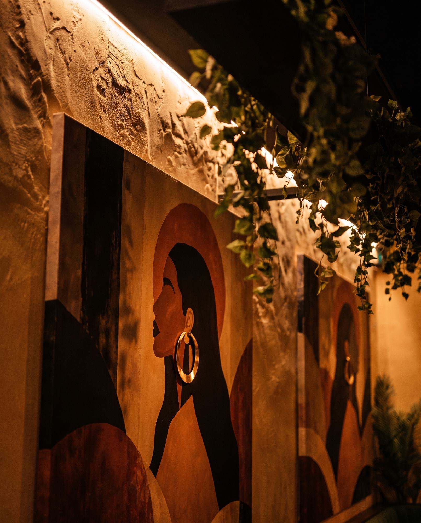 A mural of a woman in profile with a gold hoop earring
